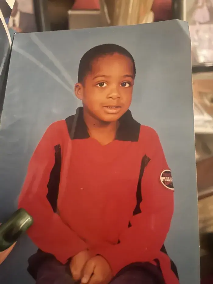 Before: original studio portrait of a child in a red shirt against a blue background