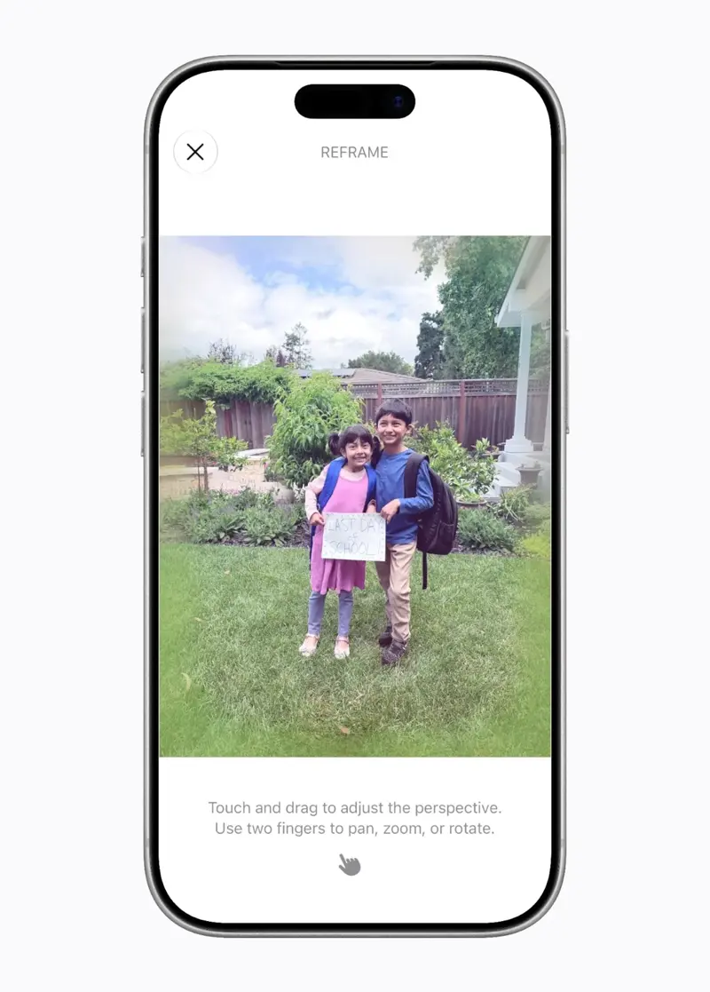 Apple’s official image of the Reframe tool in iOS 27, showing the instruction to touch and drag to adjust the perspective and use two fingers to pan, zoom, or rotate