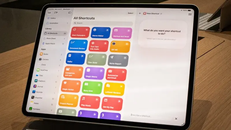 PCMag’s hands-on test of the Shortcuts app showing the “Describe a shortcut” text box, ready to accept a plain-English instruction, alongside a library of existing shortcuts